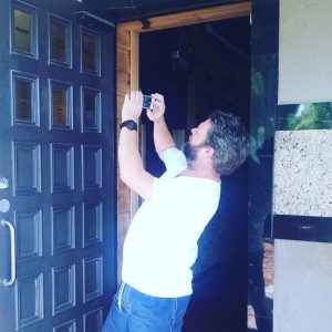 Mike Smith taking a picture of the petanque champions wall